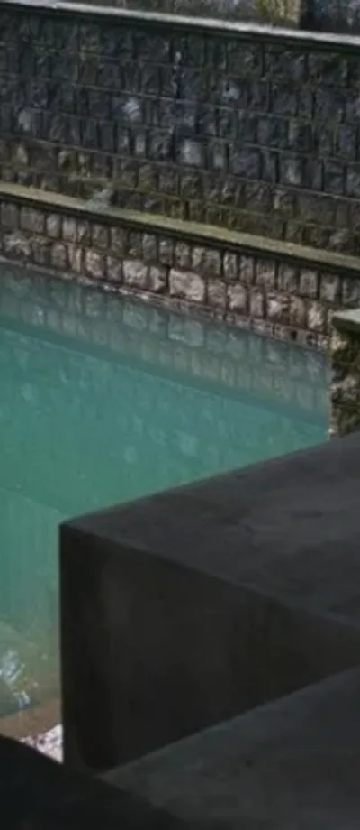 A still water tank reflecting its stone surrounds.